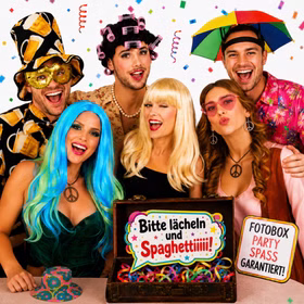 Fotobox Kostüm-Zubehör 23-tlg. – Party-Spaß für Hochzeit, Geburtstag & JGA Perücken Hüte Augenmaske Brille Haarreifen Kette Ohrringe Accessoires Mottoparty Fröhliche Gruppe mit bunten Perücken, Bierhut, Schirm-Hut und Party-Accessoires bei einer ausgelassenen Fotobox-Party mit Konfetti. Hinweis: KI generiertes Bild