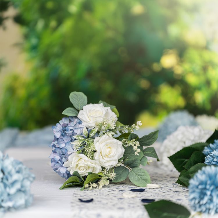 Strauß aus weißen Rosen, blauen Hortensien und grünen Blättern, Nahaufnahme.