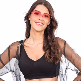 Frau trägt rosa Herz-Sonnenbrille und lächelt in die Kamera.