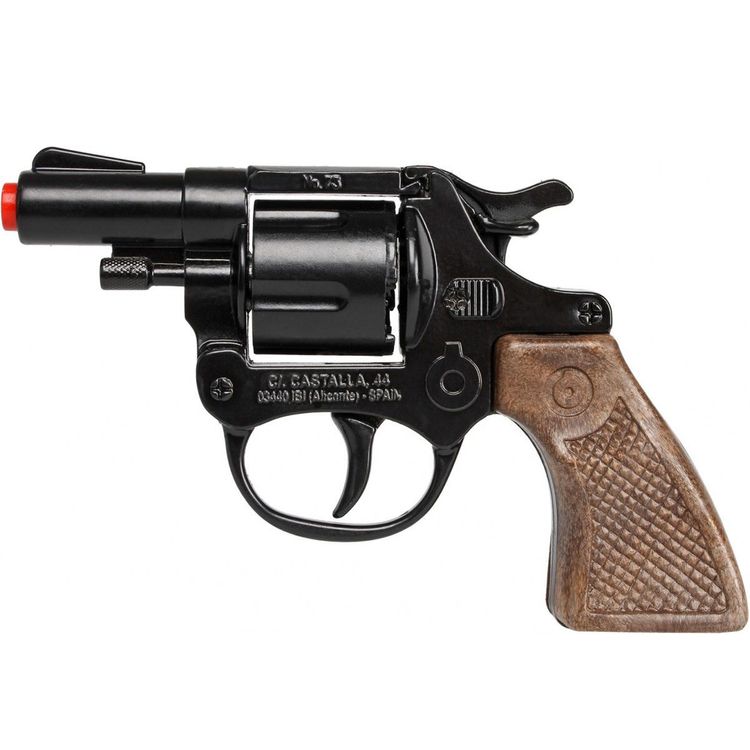 Spielzeug-Revolver mit Spielzeug-Munitionsringen im Hintergrund.