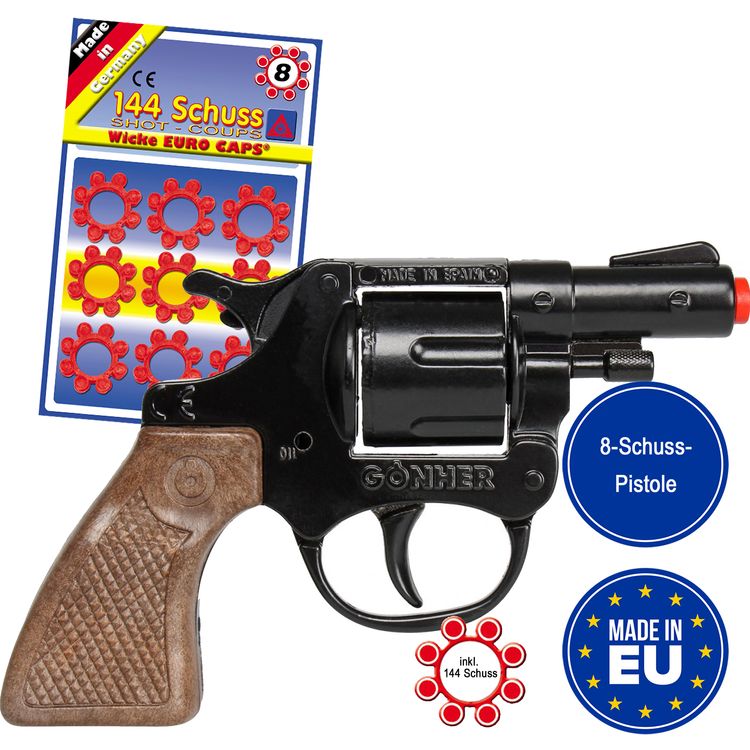 Spielzeug-Revolver mit Spielzeug-Munitionsringen im Hintergrund.