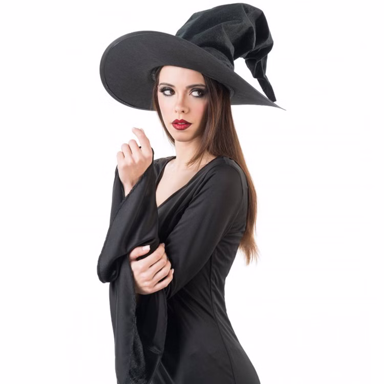 Schwarzer Hexenhut Halloween aus Samt 35 cm hoch für Damen Kostüm-Zubehör Walpurgisnacht Blocksberg Fasching Karneval Mottoparty Frau im schwarzen Kleid mit schwarzem Hexenhut seitlich von Vorne