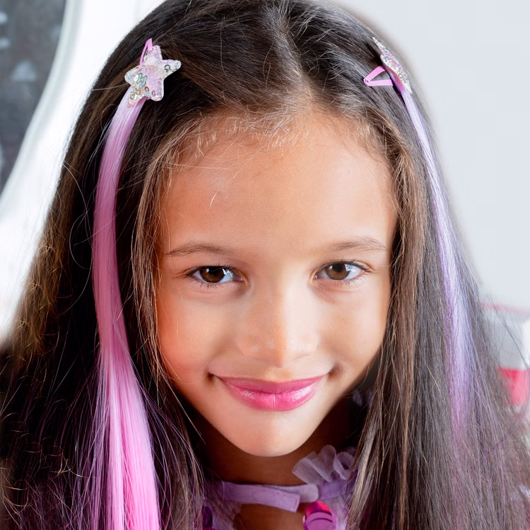 Bunte Haarsträhnen mit Clip 8 Stück Pink & Lila Prinzessin Fee Extensions für Kinder Geschenkidee Geburtstag Fasching Karneval Rollenspiel Verkleidung Mädchen trägt glitzernde Haarspangen mit pinken Strähnen als bunte Haarverlängerung im Alltag.