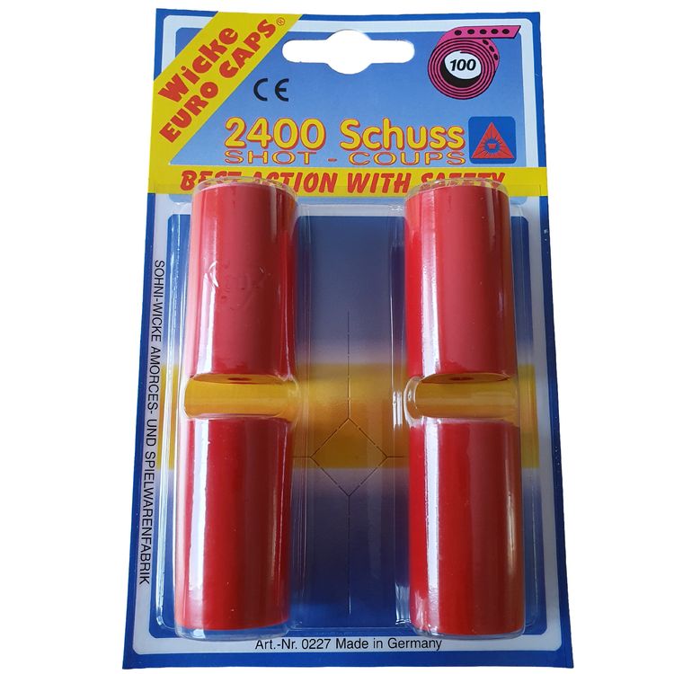 Verpackung der Wicke Euro Caps mit vier roten Rollen sowie drei zusätzliche abgewickelte Rollen mit sichtbaren Zündplättchen.