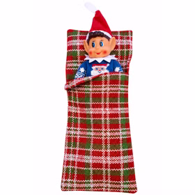 Wichteljunge im Schlafsack mit blauem Pullover Weihnachtswichteljunge mit blauem Weihnachtspullover und weißem Kragen liegt zugedeckt in einem rot-grün-weiß karierten Schlafsack. Sein Kopf und der obere Teil des Pullovers schauen heraus. Hinweis: KI generiertes Bild