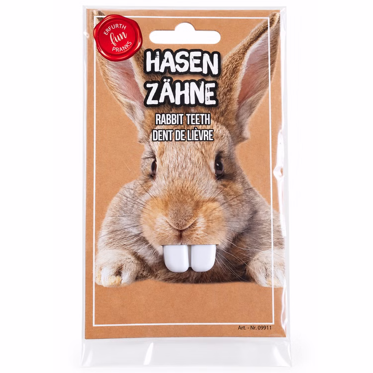 Hasenzähne weiß Kostüm Zubehör Vorderseite Weiße Hasenzähne als Kostüm-Zubehör in Originalverpackung mit Hasenmotiv, Frontansicht auf sauberem weißem Hintergrund.